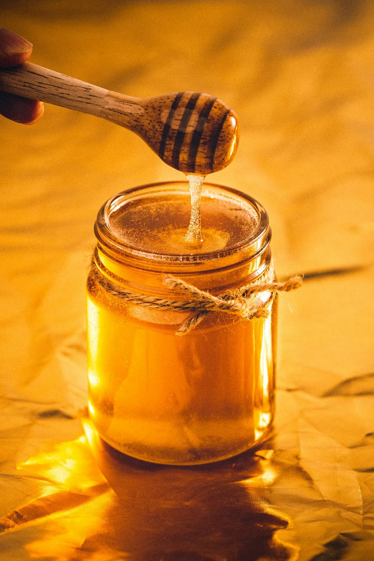 Jar of raw honey with honeycomb lid